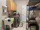 Laundry room with washer, dryer, cabinets, and utility sink at 9111 Woodbridge Oak Ter, Orlando, FL 32825