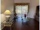 Bright living room featuring hardwood floors and sliding glass doors at 9111 Woodbridge Oak Ter, Orlando, FL 32825