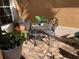 Small patio with metal table and chairs, potted plants, and tile flooring at 9111 Woodbridge Oak Ter, Orlando, FL 32825