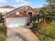 Elevated perspective of a home with a two-car garage and lush landscaping at 167 Castaway Beach Way, Kissimmee, FL 34746