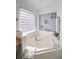 Inviting bathroom with a large soaking tub and decorative shelving at 167 Castaway Beach Way, Kissimmee, FL 34746