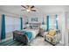 Bedroom with gray bed, teal blanket, and patterned chair at 167 Castaway Beach Way, Kissimmee, FL 34746
