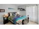 Tropical-themed bedroom with a black sleigh bed and bright sheer curtains at 167 Castaway Beach Way, Kissimmee, FL 34746