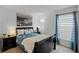 Cozy bedroom with a black sleigh bed and blue curtains at 167 Castaway Beach Way, Kissimmee, FL 34746