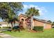 Attractive home with palm trees, lush landscaping, and a two-car garage at 167 Castaway Beach Way, Kissimmee, FL 34746