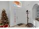 Welcoming foyer with a Christmas tree, coat rack, bench, and tiled floor at 167 Castaway Beach Way, Kissimmee, FL 34746