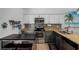 Modern kitchen with stainless steel appliances, granite countertops, and a breakfast bar at 167 Castaway Beach Way, Kissimmee, FL 34746