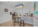 Eat-in kitchen with breakfast bar, granite countertops, and stainless steel appliances at 167 Castaway Beach Way, Kissimmee, FL 34746