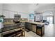 Open-concept kitchen with stainless steel appliances, granite countertops, and a wine cooler at 167 Castaway Beach Way, Kissimmee, FL 34746