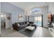 Living room with brown sectional sofa, white coffee table, and sliding glass doors at 167 Castaway Beach Way, Kissimmee, FL 34746
