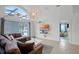 Living room with high ceilings, brown sectional sofa, and access to the pool area at 167 Castaway Beach Way, Kissimmee, FL 34746