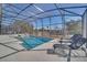 Screened pool and spa with lounge chairs at 2525 Shanti Dr, Kissimmee, FL 34746