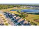 Aerial view of community with lake and homes at 3290 Logan Berry Dr, Mount Dora, FL 32757