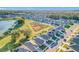 Aerial view of a community with houses, a lake, and green spaces at 3290 Logan Berry Dr, Mount Dora, FL 32757