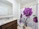 Bathroom with granite countertop, shower/tub combo, and floral shower curtain at 3290 Logan Berry Dr, Mount Dora, FL 32757