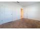 Simple carpeted bedroom with neutral walls and a door at 3290 Logan Berry Dr, Mount Dora, FL 32757