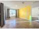 Empty bedroom with yellow accent wall and tile floors at 3290 Logan Berry Dr, Mount Dora, FL 32757