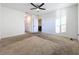 Spacious bedroom with ceiling fan and neutral carpeting at 3290 Logan Berry Dr, Mount Dora, FL 32757
