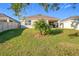Single story home with backyard and palm tree at 3290 Logan Berry Dr, Mount Dora, FL 32757