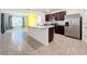 Kitchen with island, stainless steel appliances, and granite countertops at 3290 Logan Berry Dr, Mount Dora, FL 32757