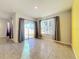 Living room with tile floors, sliding glass doors, and backyard view at 3290 Logan Berry Dr, Mount Dora, FL 32757