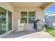 Covered patio with grill and sliding glass doors at 3290 Logan Berry Dr, Mount Dora, FL 32757