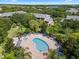 Resort-style pool with a hot tub, surrounded by lounge chairs and palm trees at 411 Lucaya Loop # 411, Davenport, FL 33897