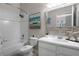 Clean bathroom with a tub, shower, and updated vanity with a mirror at 411 Lucaya Loop # 411, Davenport, FL 33897