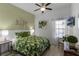 Bedroom with a queen-size bed, tropical decor, and a ceiling fan at 411 Lucaya Loop # 411, Davenport, FL 33897