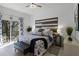 Spacious bedroom with a king-size bed and sliding glass doors leading to a balcony at 411 Lucaya Loop # 411, Davenport, FL 33897