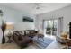 Spacious living room with leather sofa, armchair, and access to balcony at 411 Lucaya Loop # 411, Davenport, FL 33897