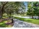 Scenic walkway with benches alongside a tranquil lake at 411 Lucaya Loop # 411, Davenport, FL 33897