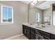 Bathroom with double vanity, large mirror, and window at 4700 Nathan Hale Blvd, St Cloud, FL 34769