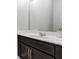 Bathroom with dark vanity and a large mirror at 4700 Nathan Hale Blvd, St Cloud, FL 34769