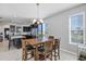 Breakfast nook with wood table and chairs, adjacent to a modern kitchen at 4700 Nathan Hale Blvd, St Cloud, FL 34769