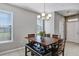 Bright dining room with a wooden table, bench seating, and a chandelier at 4700 Nathan Hale Blvd, St Cloud, FL 34769
