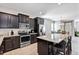 Modern kitchen with island, stainless steel appliances, and granite countertops at 4700 Nathan Hale Blvd, Saint Cloud, FL 34769