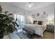 King-size bed, private balcony access, and coastal decor at 608 Gran Bahama Blvd # 608, Davenport, FL 33897
