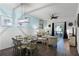 Dining area with glass-top table and light blue chairs, open to living room at 608 Gran Bahama Blvd # 608, Davenport, FL 33897