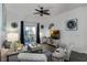 Living room with gray couch, patterned armchairs, and access to a balcony at 608 Gran Bahama Blvd # 608, Davenport, FL 33897