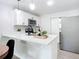Modern kitchen with white cabinets and a breakfast bar at 736 N Segrave St, Daytona Beach, FL 32114