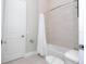 Clean bathroom with bathtub, toilet and light tile at 7740 Sandy Ridge Dr # 9-236, Kissimmee, FL 34747