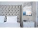 Elegant bedroom with upholstered headboard, nightstands and large windows at 7740 Sandy Ridge Dr # 9-236, Kissimmee, FL 34747