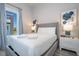 Bright bedroom with a queen-size bed, nightstands, and large window at 7740 Sandy Ridge Dr # 9-236, Kissimmee, FL 34747