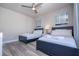 Bedroom with two twin-size beds and ceiling fan at 7740 Sandy Ridge Dr # 9-236, Kissimmee, FL 34747