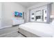 Comfortable bedroom with large windows, dresser, and a TV at 7740 Sandy Ridge Dr # 9-236, Kissimmee, FL 34747