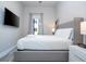 Bedroom with a king-size bed, TV, and access to bathroom at 7740 Sandy Ridge Dr # 9-236, Kissimmee, FL 34747