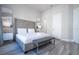 Bright bedroom with a plush bed, gray bench, and ample closet space at 7740 Sandy Ridge Dr # 9-236, Kissimmee, FL 34747