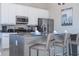 Modern kitchen with stainless steel appliances and an island at 7740 Sandy Ridge Dr # 9-236, Kissimmee, FL 34747