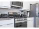 Modern kitchen with stainless steel appliances and an island at 7740 Sandy Ridge Dr # 9-236, Kissimmee, FL 34747